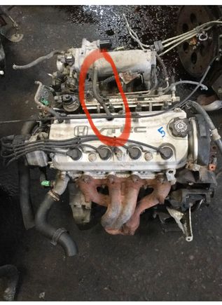 This wire circled is missing. I’m not in front of the car now but found a pic of the same engine.