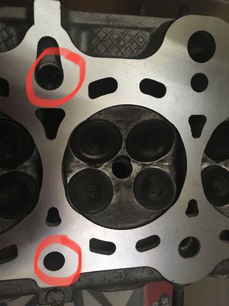 It looks like the oil flows around the bolt hole since it’s bigger than the one pictured on the bottom.