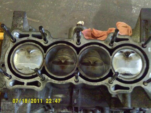 Used set of K20 pistons resting inside of the freshly 1mm bored out F22a1 Block. Also note, the 6 oil drain ports on the block's deck, hence the reason for blocking the 2 in the Head