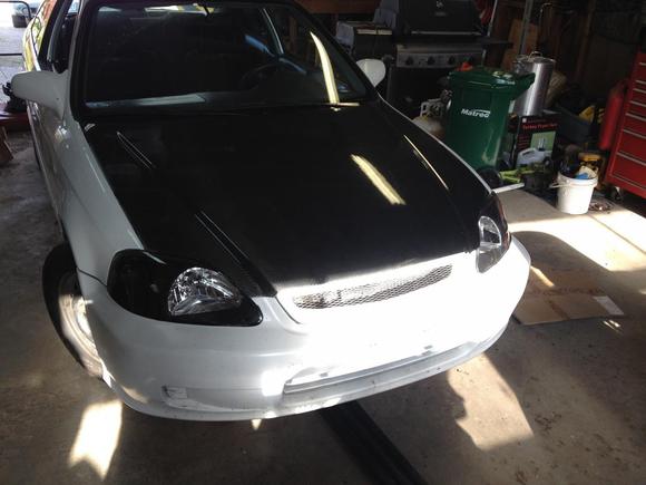 Carbon fibre hood and black housing headlights with HID's. 
Just put them on to see how it looked, however it will be coming off when I pull the motor.