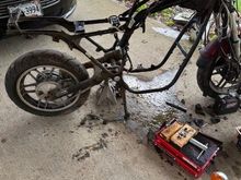 Got it down to the frame. Had to replace the swing arm, since the cross brace was rusted through on the original. 
