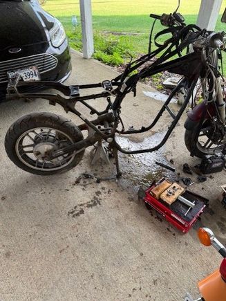 Got it down to the frame. Had to replace the swing arm, since the cross brace was rusted through on the original. 