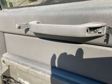 As others assured me getting the door panel off is super easy.  You flip open the two little tabs on the grab handle and remove the two screws securing it to the steel inner panel.