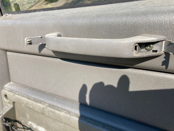 As others assured me getting the door panel off is super easy.  You flip open the two little tabs on the grab handle and remove the two screws securing it to the steel inner panel.