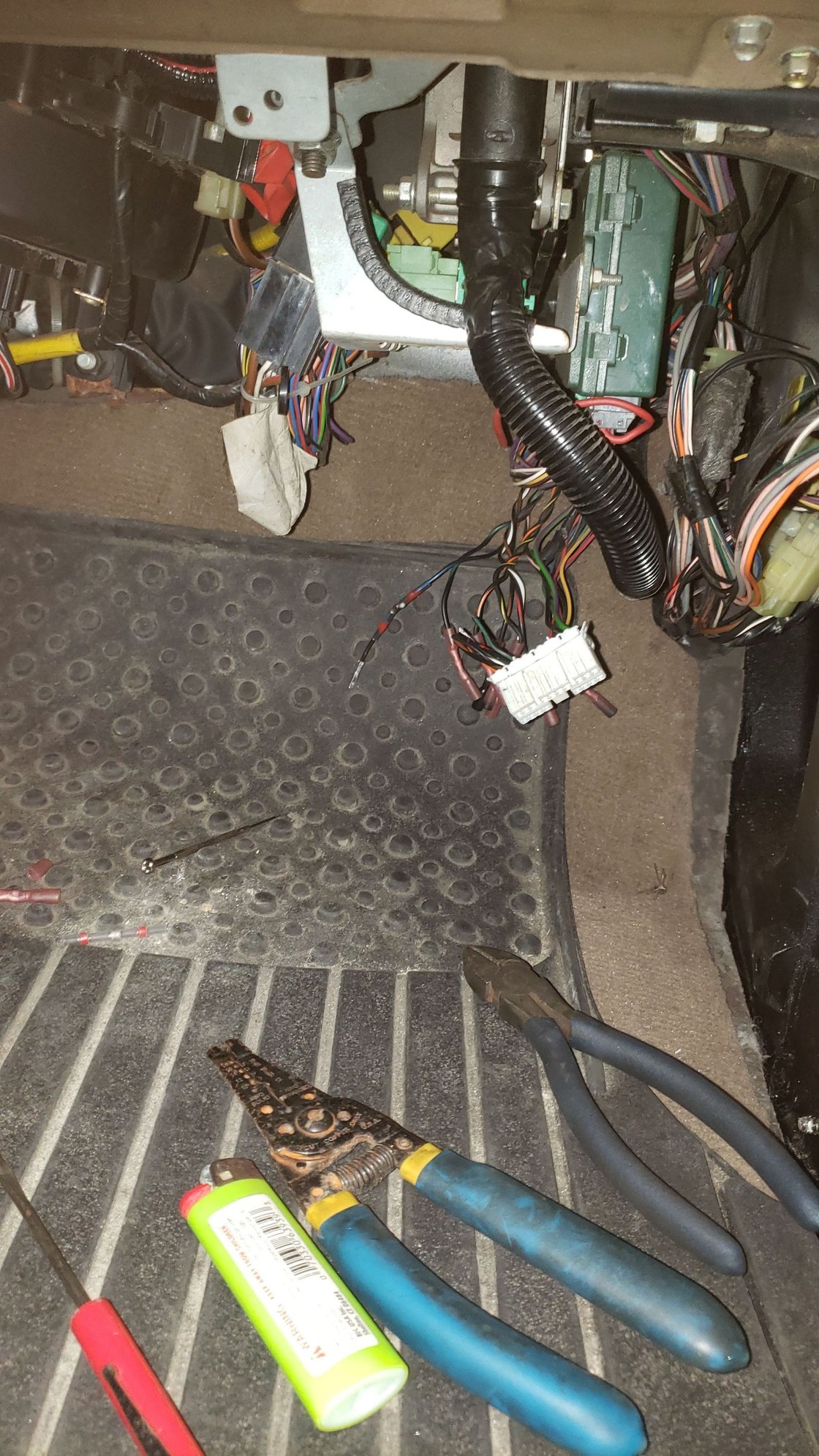 Cut harness by passenger footwell.