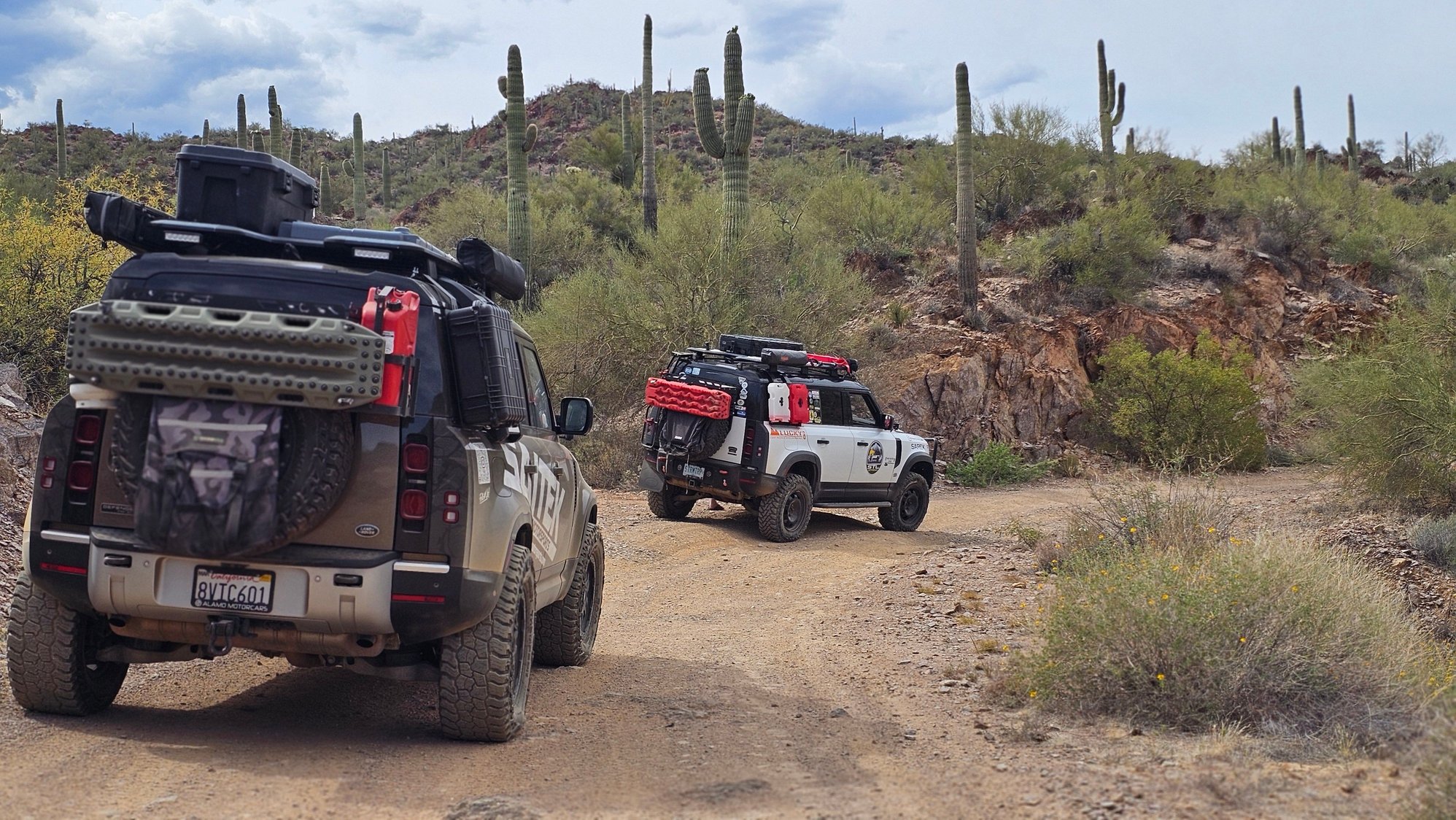 Both defender have our tailgate rack. Our is carrying a  full jerry can that weighs 40lbs a propane tank that weighs 15lbs and the maxtrax extreme that weights 20lb. The rack itself weighs 40lbs and the 35s and wheel combo weight about 112lbs. Oem weighed about 75lbs