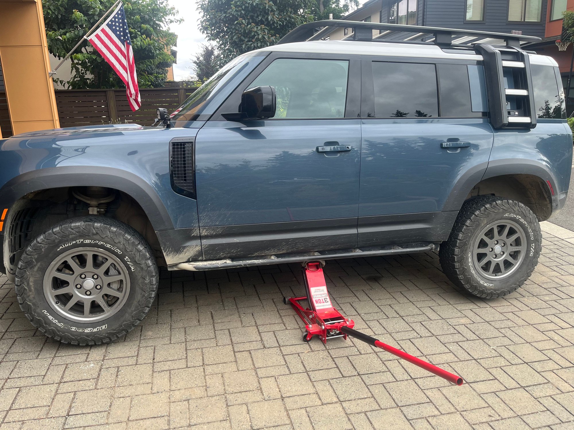 Jack and slider. Pinch welds work just as well for lifting. 