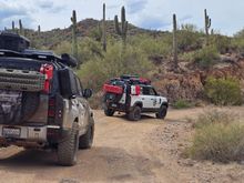Both defender have our tailgate rack. Our is carrying a  full jerry can that weighs 40lbs a propane tank that weighs 15lbs and the maxtrax extreme that weights 20lb. The rack itself weighs 40lbs and the 35s and wheel combo weight about 112lbs. Oem weighed about 75lbs