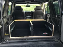 Rear seats removed and cargo area gutted. Drawer system base installed.