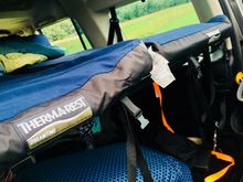 2 self inflating mattress that can accommodate up to 6 ft. 4 inches tall on a convertible deck that can be used as a table as well.