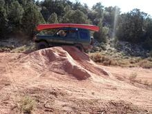 climbing a nearly vertical dirt bike jump after scaring away local gang of dirt bike kids