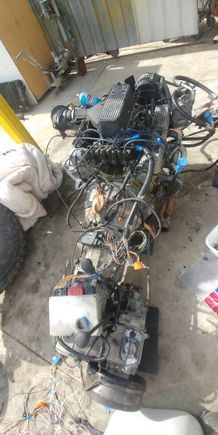 Engine harness and ecu plugged in and laying on tranny