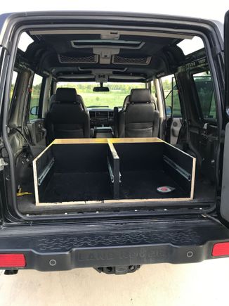 Rear seats removed and cargo area gutted. Drawer system base installed.