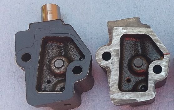 The tensioner on the left was new in 2012.  It uses a gasket where the tensioner on the right does not.