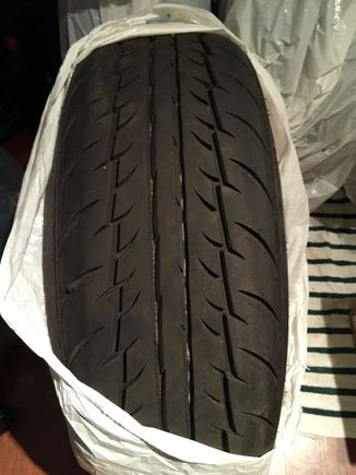 The white lines you see in the tread is not a defect. It's the marks when the tires were new.