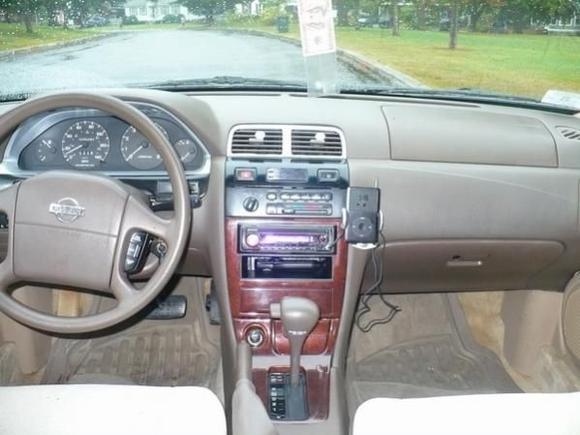 Here she is. I have no clue what i was thinking by painting middle ac vents and the bezel around the speedometer silver. Also that ipod holder from walmart had to go. I still have 2 holes because of it. Best part was the woodgrain. Bought all the pieces for $65 in the junkyard in great condition.
