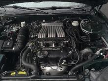 Under the hood the day I got it. Completely 100% stock.