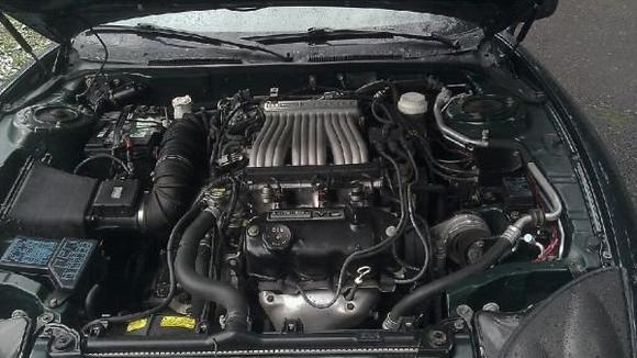 Under the hood the day I got it. Completely 100% stock.