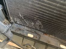 It’s out! 
But not without damage to the AC condenser.  