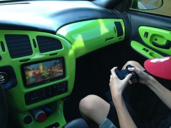 My 2nd oldest son playing the Playstation 3 while I'm driving.