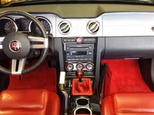 judicious use of Roush dashboard laminate for radio surround to connect the re-finished floor console. Note the 1967 dash medallion and chrome trim at top of silver dash panels