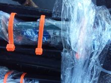 Bolts for each side are zip-tied, for security and wrapped, inside each upright.