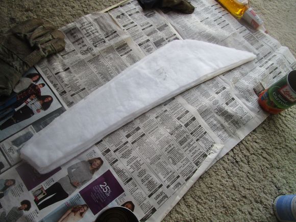 Masonite panel with three layers of polyester medium-weight batting glued on top in decreasing sizes of 1/4" less for each layer