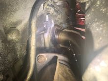 This photo shows two things. Oil is running down the back of the engine right where the bell housing connects. It also is pooled on the bottom of the #4 header 