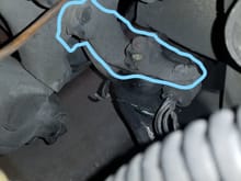 Here is the broken passenger side bracket. Lower side of upper left end in the picture is where the lip that attaches to the clamshell broke off.