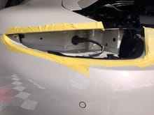 Driver side tail lens where main rear bumper harness attachment is located