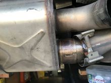 RH cat piping inserted into muffler at least 1". See at top of pipe there is about 3/8" the muffler could slide sideways