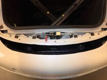 and looking straight down (i tried shining a light so you can see among the black parts in the darkness) the direct shot to the back of the rad retaining frame.