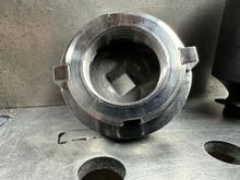 This another view (2 of 2) of the handmade slot spanner wrench I fashioned from a 1-11/16' 6-point impact socket.  The original slotted bearing retainer nut is mounted to the socket in the image.