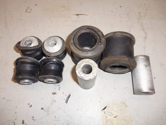 Old bushings and sleeves from upper and lower control arms.