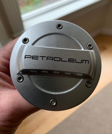 PETROEUM lettering is laser-etched into the surface of the cap. High quality work.