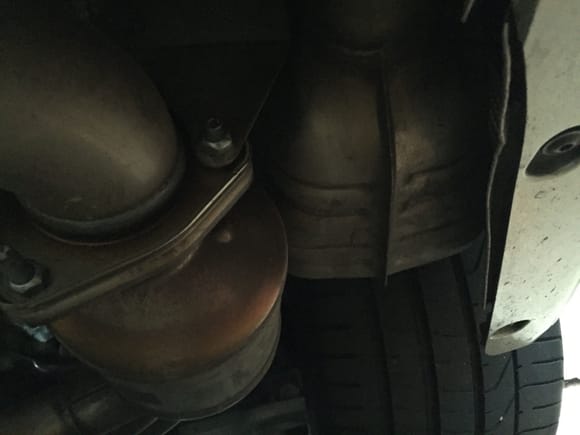 One of the two side mufflers behind the rear wheels. Those stay on the S model. The round thing next to the muffler is a catalytic converter.