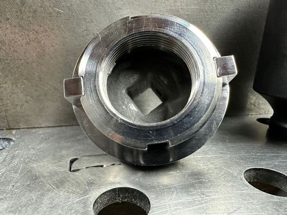 This another view (2 of 2) of the handmade slot spanner wrench I fashioned from a 1-11/16' 6-point impact socket.  The original slotted bearing retainer nut is mounted to the socket in the image.