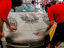 The guys from Clear Auto Bra are installing XPEL ULTIMATE on the hood of this custom painted Corvette