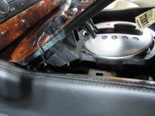 There was enough room to remove the assembly and insert the new dust cover from the back without unplugging anything. That is a switch for the Sirius antenna by the parking brake.  The pin and fitting a clear here and at 9:00 on the shifter cover. 