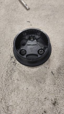 Top view of the mount screwed into the top of the rubber stopper.  You can see the hole drilled through the stopper at about 10 o'clock for the tweeter wires to pass through.