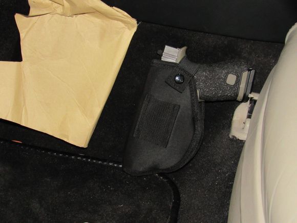 Glock 43 At transmission tunnel, drivers side.