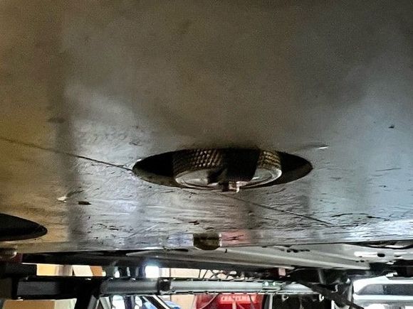 Capped valve in place with undertray installed. It barely protrudes through the hole in the tray.