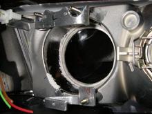 the brackets I made, bolted down inside the housing to the original (2001) projector mounts.  Notice the diameter of the lens opening has also been carefully enlarged.