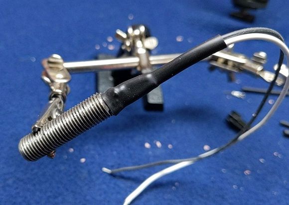 The next morning I covered both wires with a 1/4" heat shrink tubing and shrunk that. I then stripped the insulation off the remaining ends.