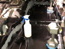 Original floor pan plugs glued back in, weighted while the sealer cures