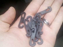 These are the clips, they attach to the elastic bands and then are supposed to clip to the metal bands under the seats.