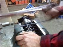 cutting the bent spring compressor