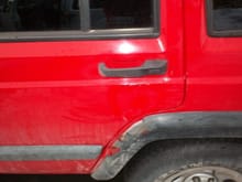 Cracked fender flare, fender is pushed back a tiny bit also, door dent behind handle and dent below door handle cannot be seen very well
