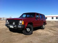 XJ Jeep Inferno Red Full side before lift and tires.