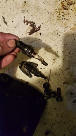 Amazing what falls behind engine mounts! 2 spark plugs ...1 melted up and a dist...mounting tab..bet he was ticked dropping that at 1 time.